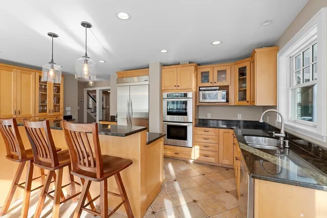 a view of a dining room with furniture a chandelier and wooden floor