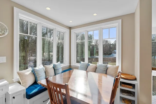 a living room with furniture a flat screen tv and a window