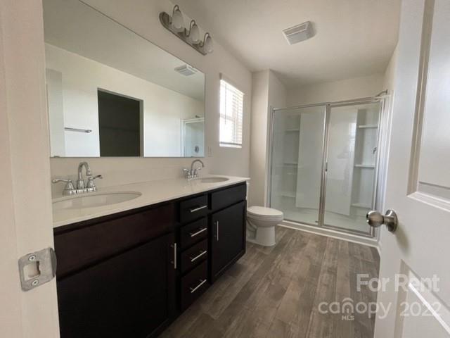 809 Alexander Commons Drive, Unit 34 Monroe, NC 28112 - Photo 19 of 28 a bathroom with a double vanity sink a toilet and mirror
