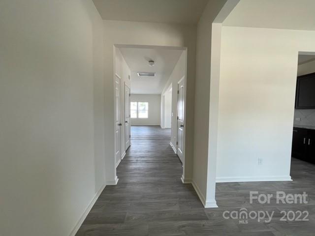 809 Alexander Commons Drive, Unit 34 Monroe, NC 28112 - Photo 3 of 28 a view of a hallway with wooden floor and glass door