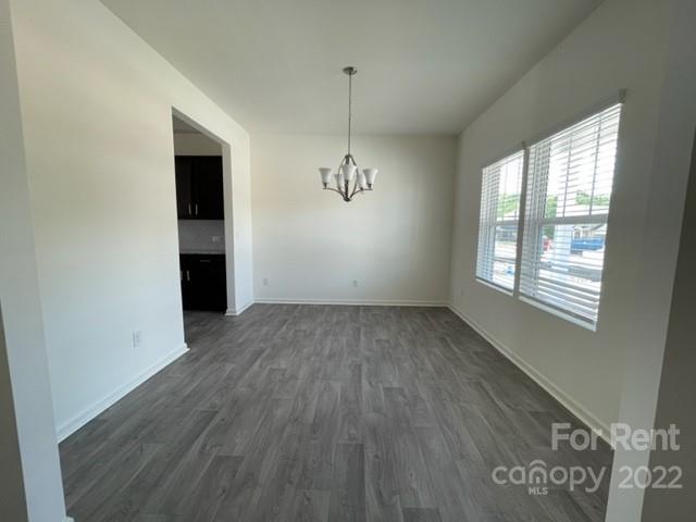 809 Alexander Commons Drive, Unit 34 Monroe, NC 28112 - Photo 4 of 28 wooden floor in an empty room with a window
