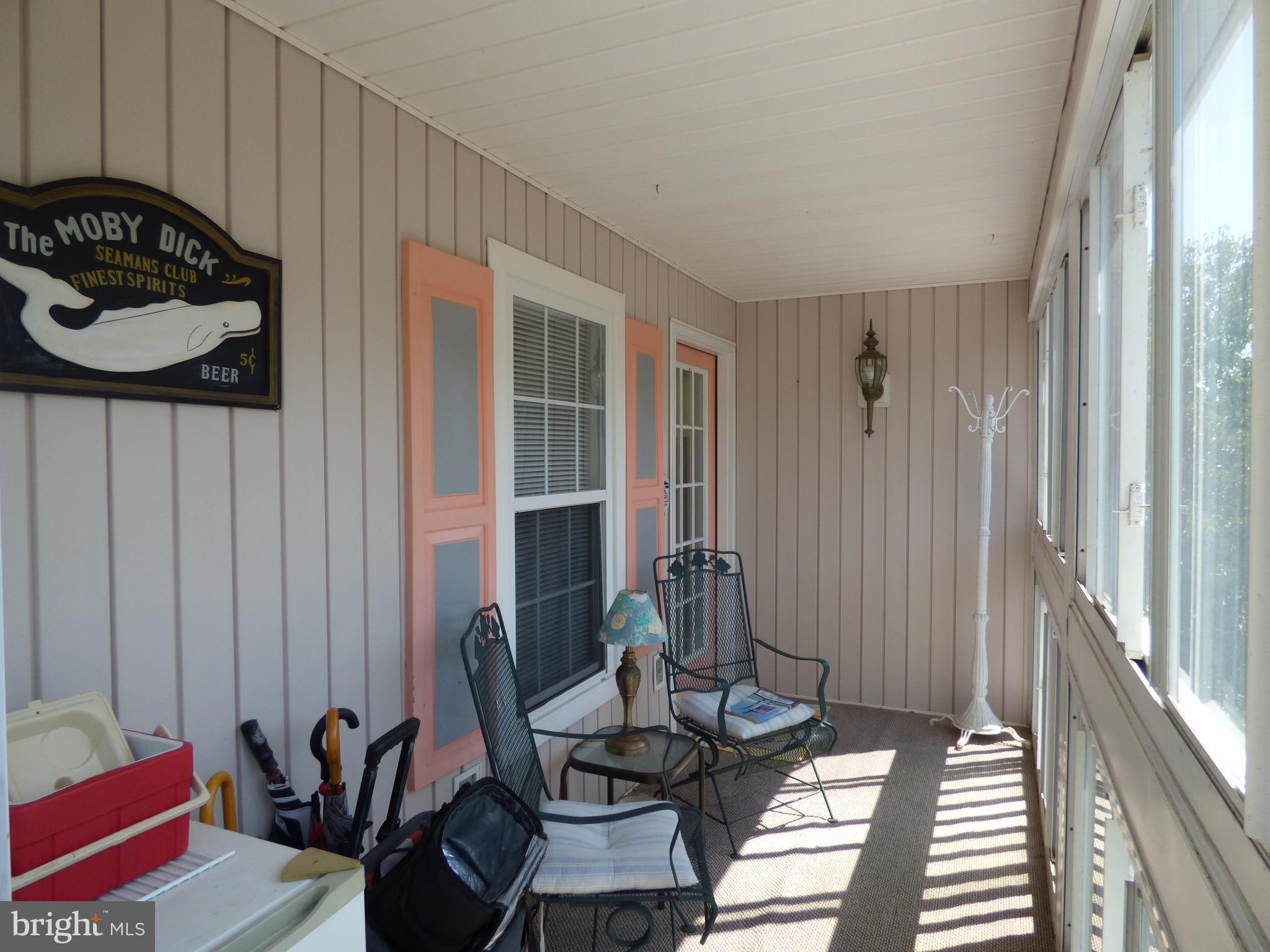 635 Sandy Point Road, Unit 31 Bethany Beach, DE 19930 - Photo 4 of 46 Enclosed sun room and front entrance