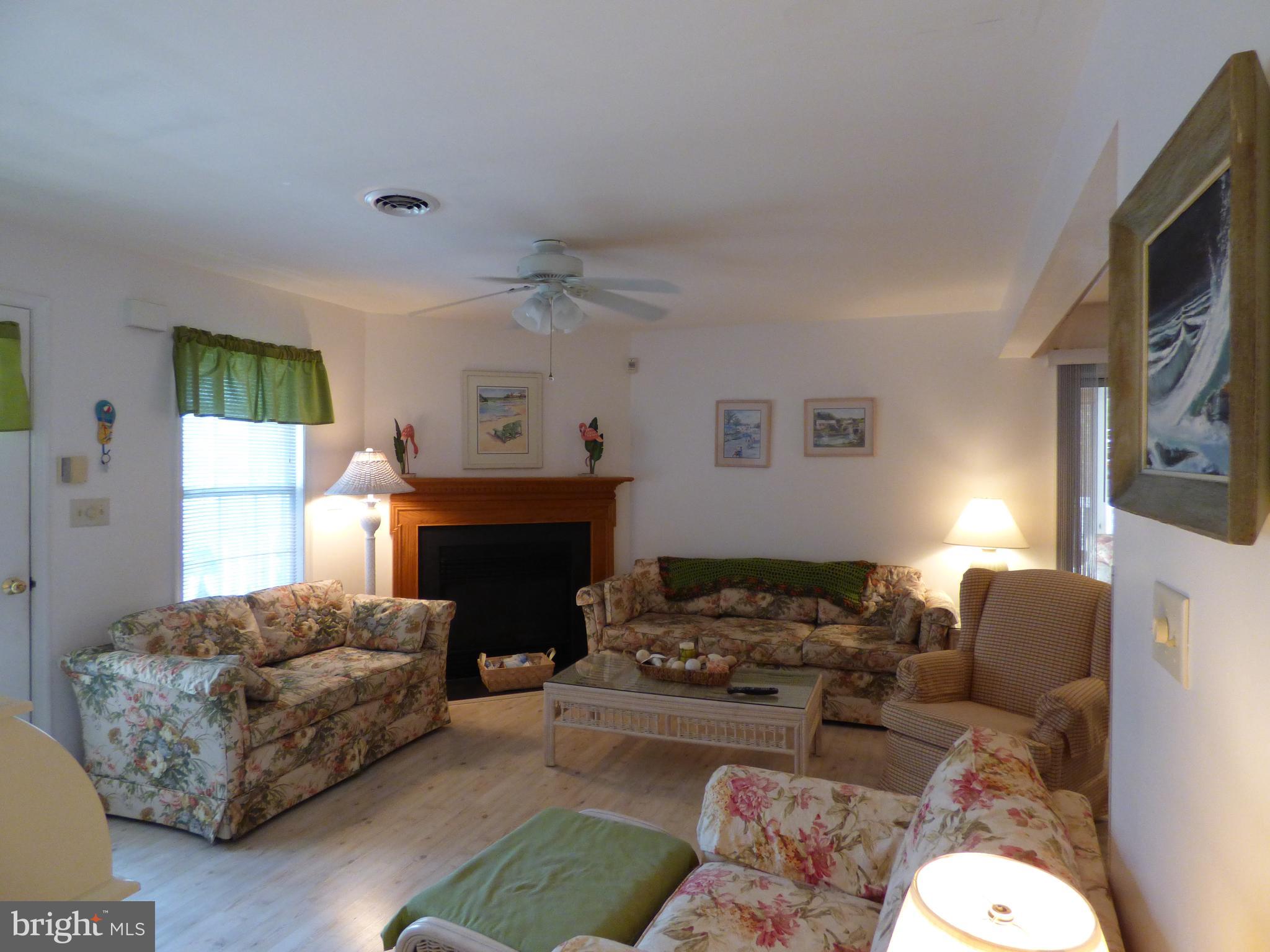 635 Sandy Point Road, Unit 31 Bethany Beach, DE 19930 - Photo 6 of 46 Living room with fireplace