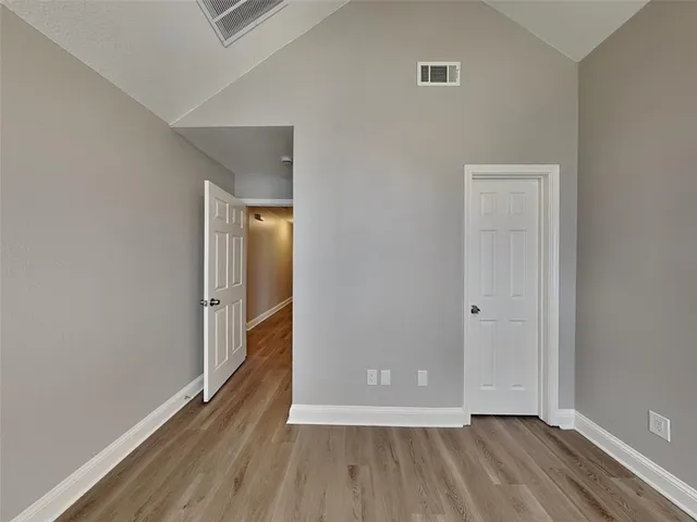 a view of an empty room and wooden floor