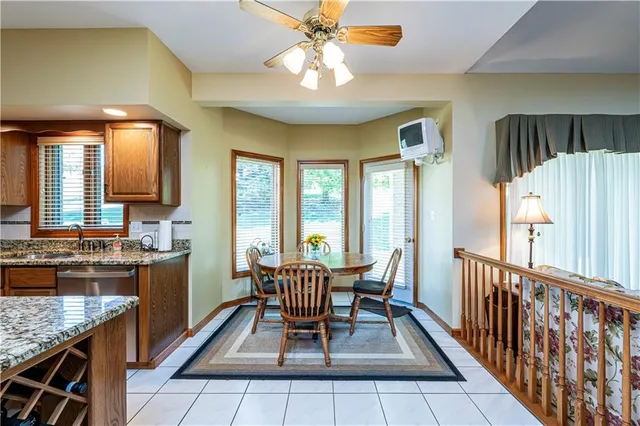 a view of a dining room with furniture and a chandelier