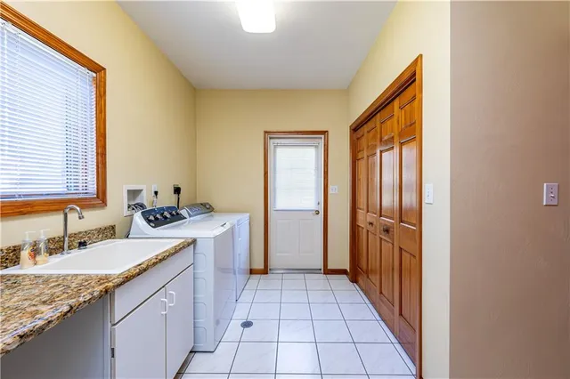 a bathroom with a granite countertop sink a mirror and a bathtub
