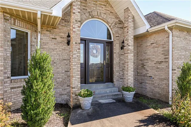 a front view of a house with potted plants