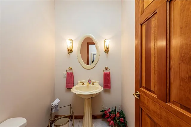 a bathroom with a sink mirror and toilet