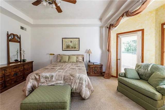 a bedroom with a bed a couch and a window