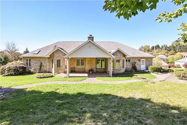 a front view of a house with swimming pool having outdoor seating