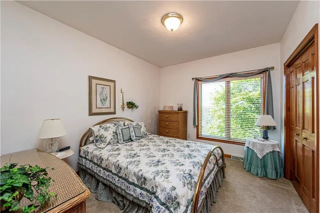 a bedroom with a bed and a large window
