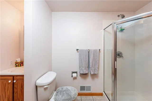 a bathroom with a toilet and a shower