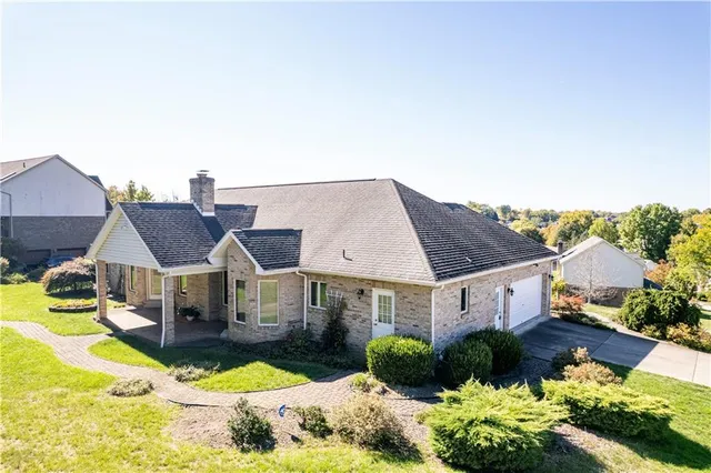 a front view of house with yard and outdoor seating