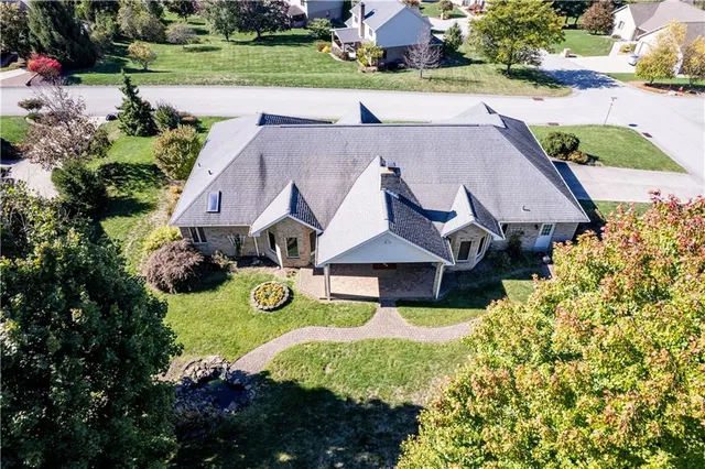 an aerial view of a house with yard swimming pool and outdoor seating