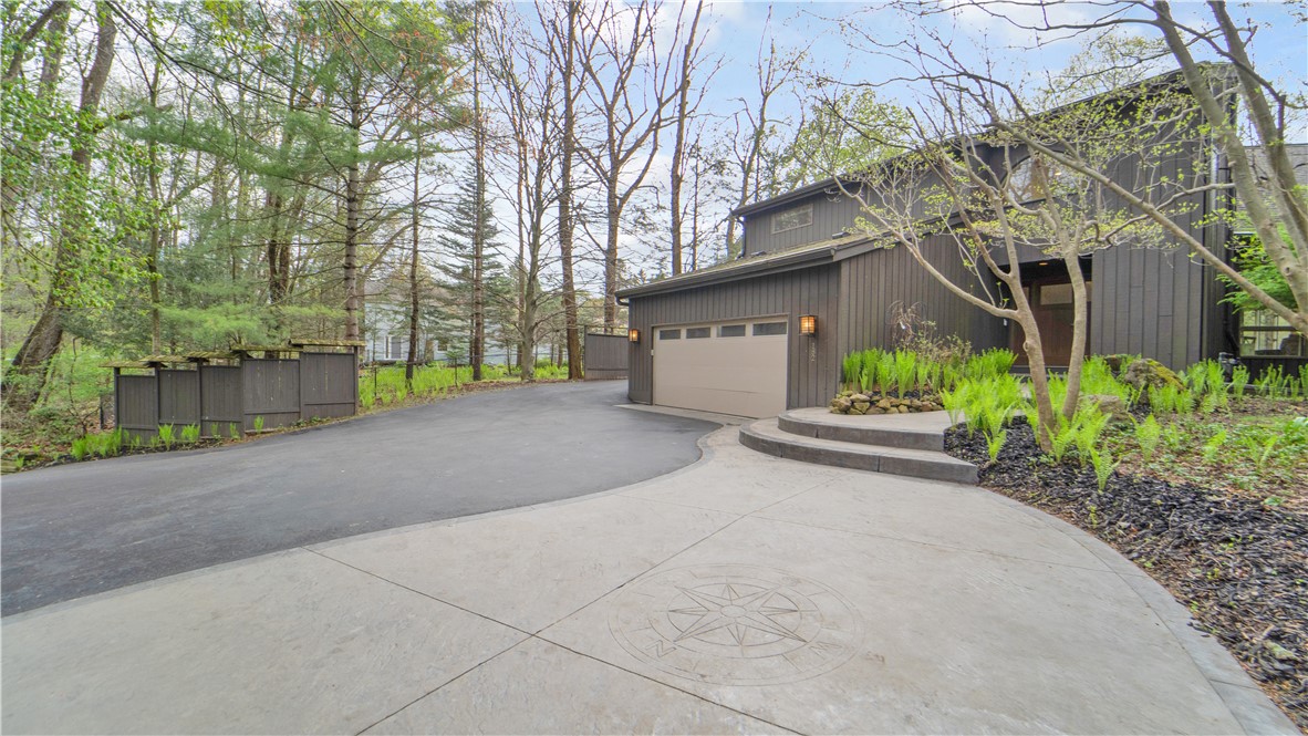 182 Park Road Perinton, NY 14534 - Photo 2 of 50 A flowing walkway winds through the trees filled w