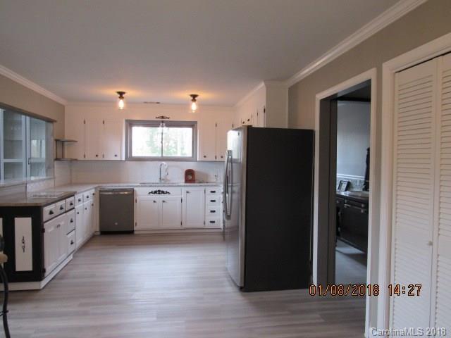 1045 Garnette Road Lancaster, SC 29720 - Photo 4 of 24 a kitchen with a refrigerator a sink and cabinets