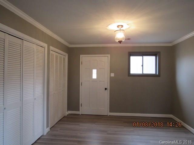 1045 Garnette Road Lancaster, SC 29720 - Photo 6 of 24 a view of an empty room with wooden floor and a window