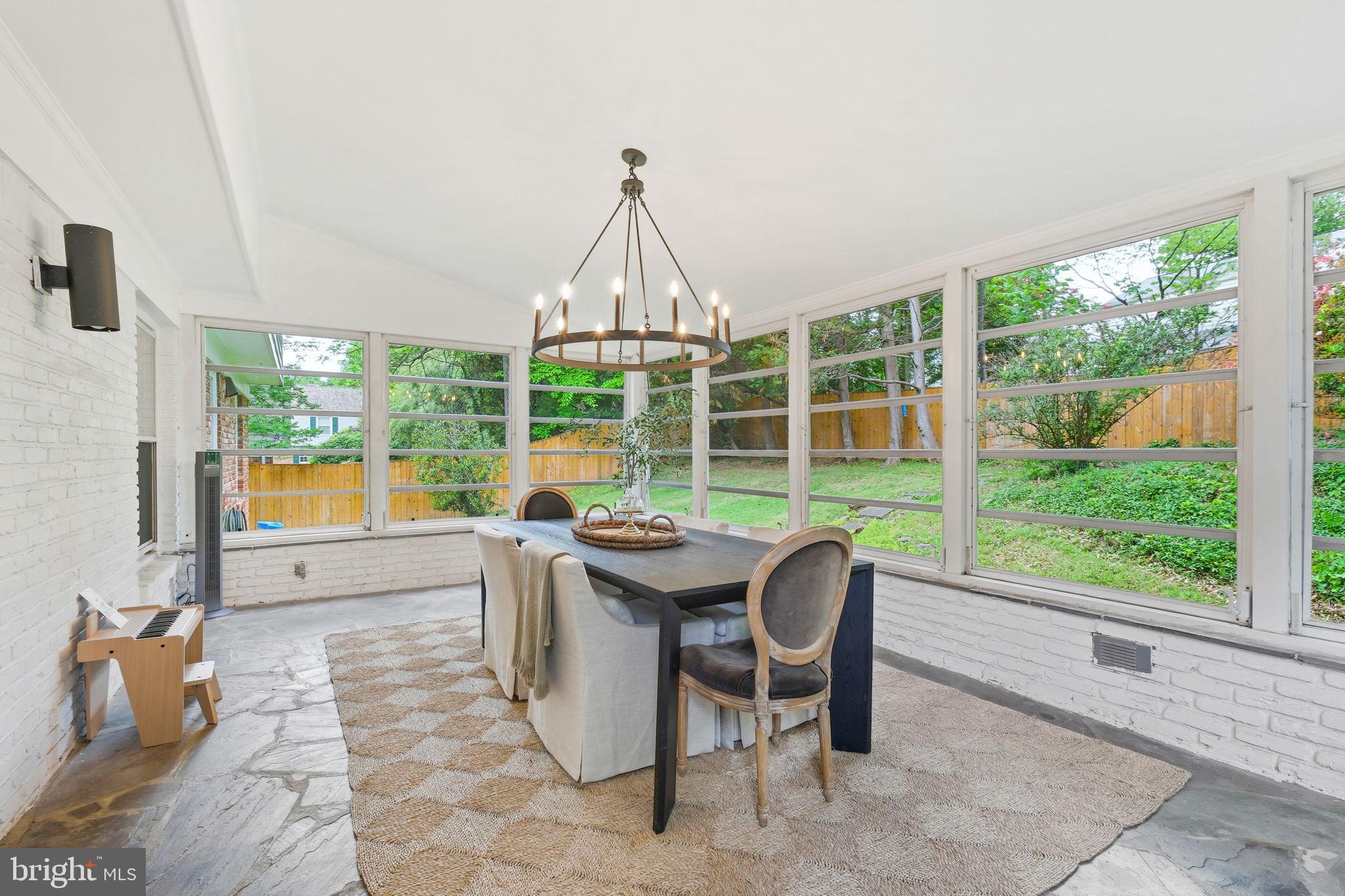 10900 Gainsborough Road Potomac, MD 20854 - Photo 19 of 44 a dining room with furniture and a garden view