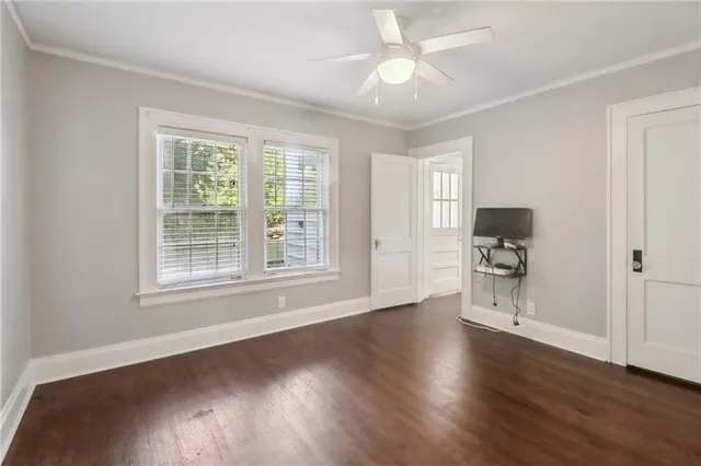 a view of a livingroom with wooden floor and a ceiling fan