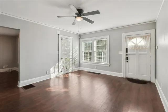 wooden floor in an empty room with a window