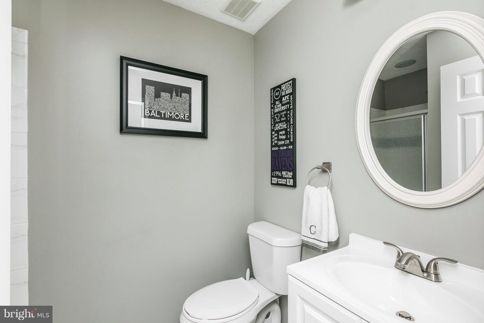 890 Lowe Road Middle River, MD 21220 - Photo 5 of 24 a white toilet sitting next to a bathroom sink