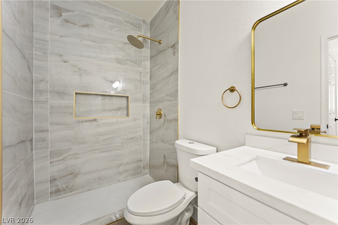 4730 East Craig Road, Unit 1053 Las Vegas, NV 89115 - Photo 17 of 32 Elegant gold-tone fixtures complement the sleek marble-tiled shower in this well-appointed bathroom.