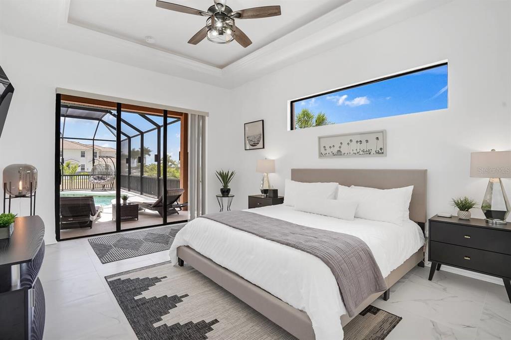 24017 Peppercorn Road Punta Gorda, FL 33955 - Photo 14 of 38 a bedroom with a large bed and a large window