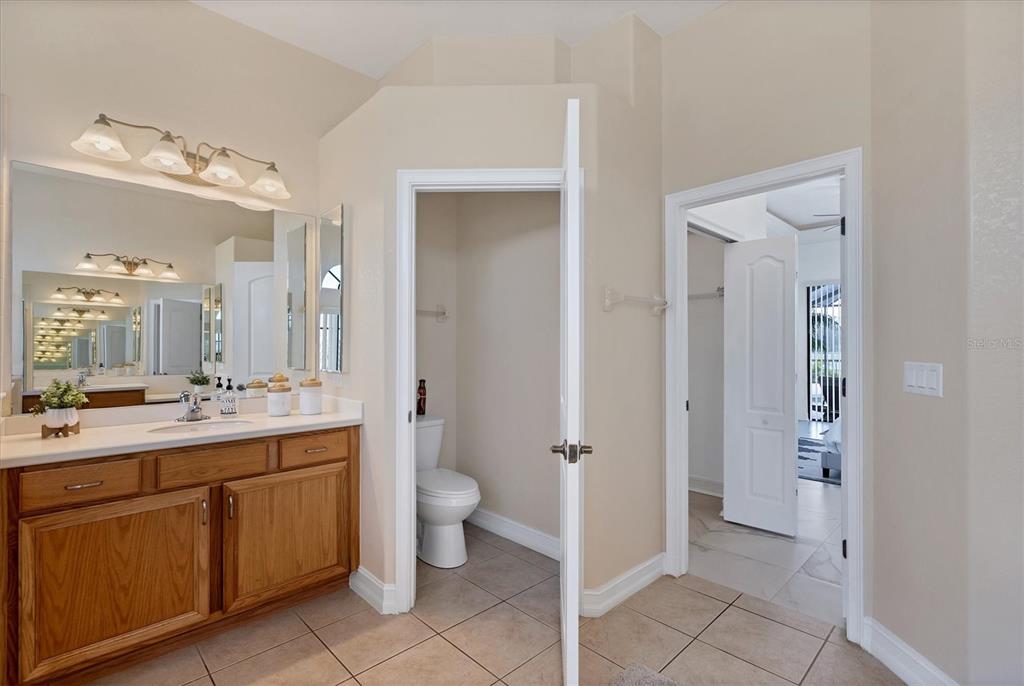 24017 Peppercorn Road Punta Gorda, FL 33955 - Photo 18 of 38 a spacious bathroom with a double vanity sink toilet mirror and double