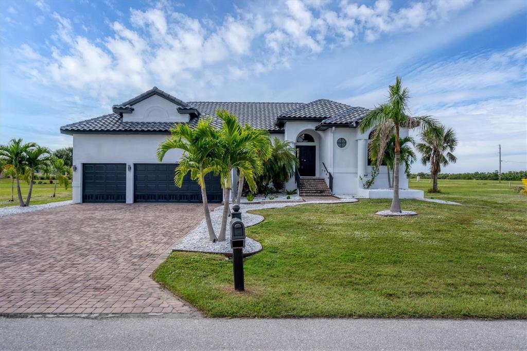 24017 Peppercorn Road Punta Gorda, FL 33955 - Photo 2 of 38 a front view of a house with garden
