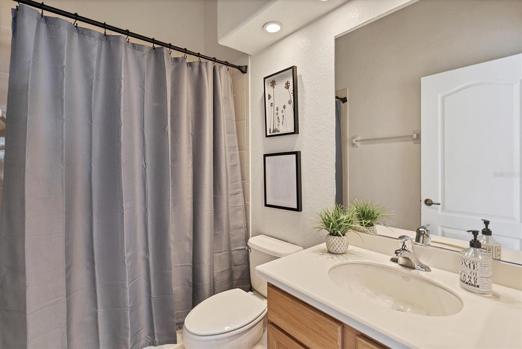 24017 Peppercorn Road Punta Gorda, FL 33955 - Photo 23 of 38 a bathroom with a sink a toilet and shower curtain