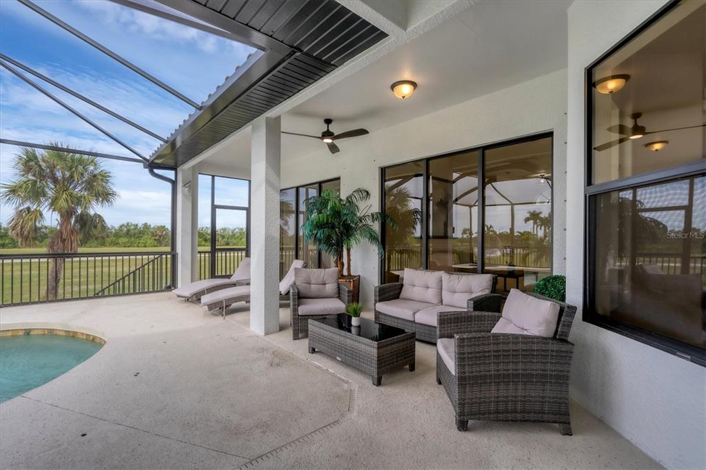 24017 Peppercorn Road Punta Gorda, FL 33955 - Photo 30 of 38 a balcony with furniture and a garden