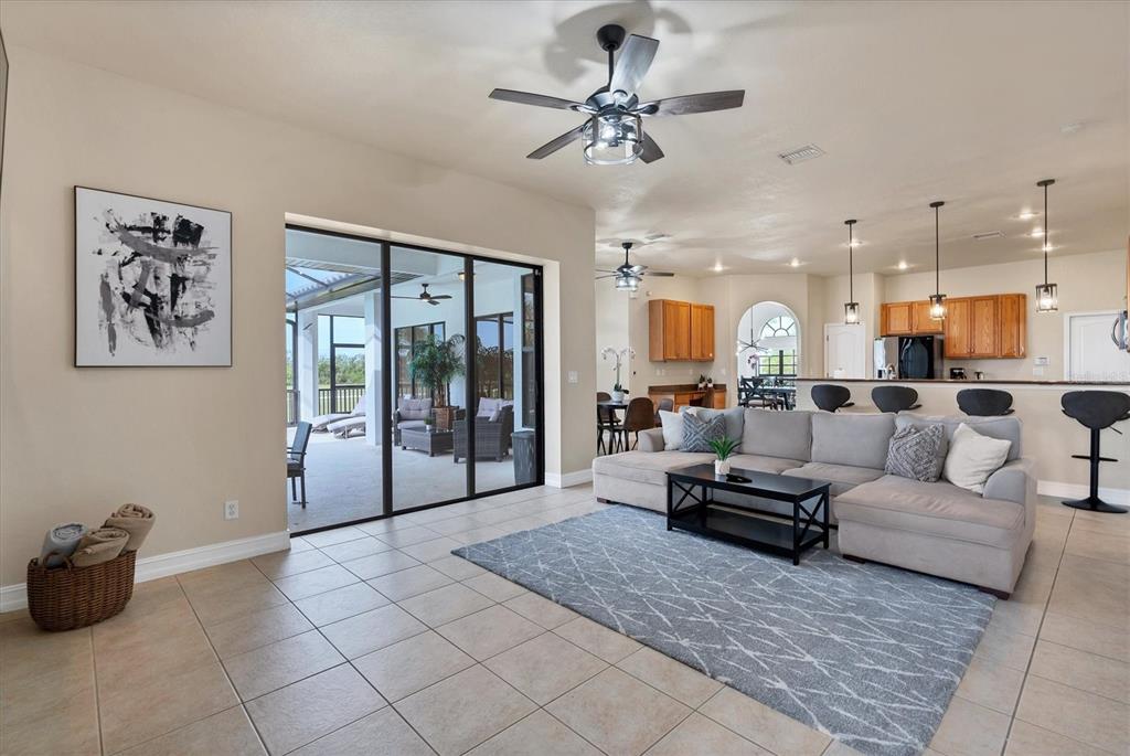 24017 Peppercorn Road Punta Gorda, FL 33955 - Photo 3 of 38 a living room with furniture and a chandelier