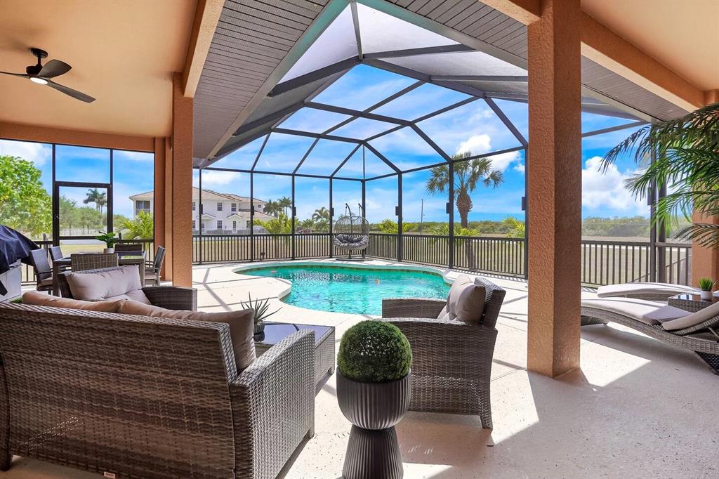 24017 Peppercorn Road Punta Gorda, FL 33955 - Photo 33 of 38 a view of a patio with couches chairs and a yard