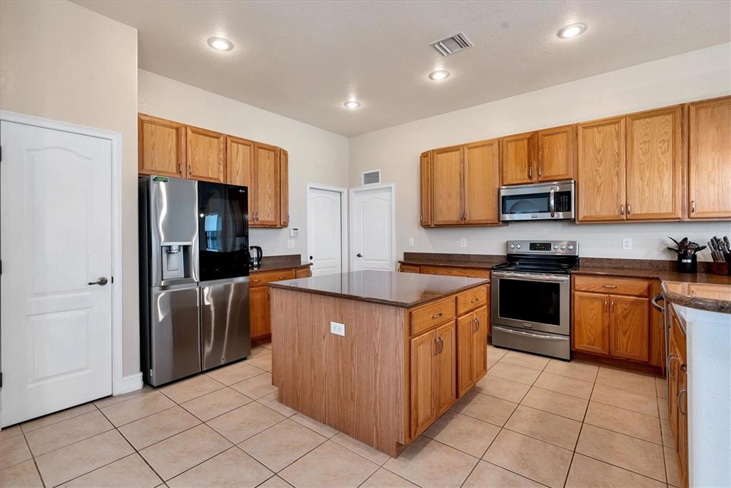 24017 Peppercorn Road Punta Gorda, FL 33955 - Photo 9 of 38 a kitchen with stainless steel appliances granite countertop a stove a sink and a refrigerator