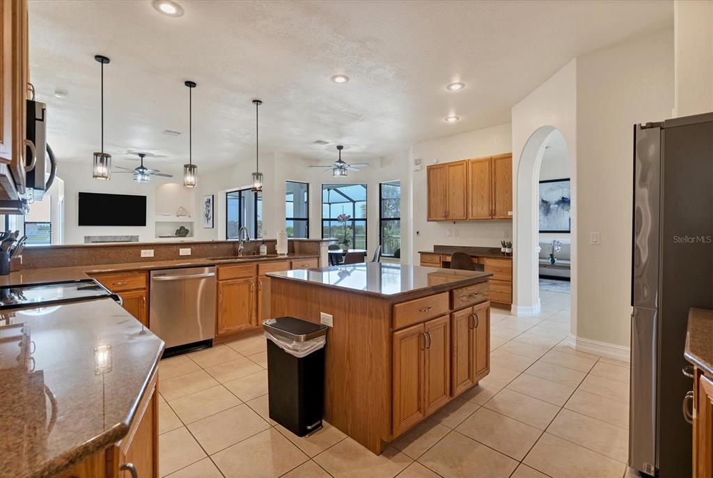 24017 Peppercorn Road Punta Gorda, FL 33955 - Photo 10 of 38 a kitchen with stainless steel appliances granite countertop a sink a stove and a refrigerator