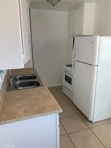 a kitchen with a stove and a refrigerator