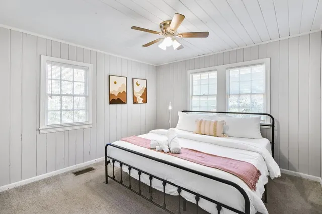 a bedroom with a large bed and a window