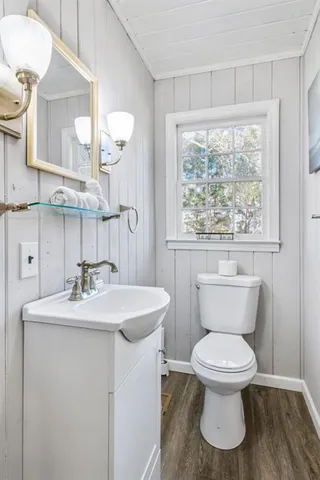 a bathroom with a toilet sink and mirror