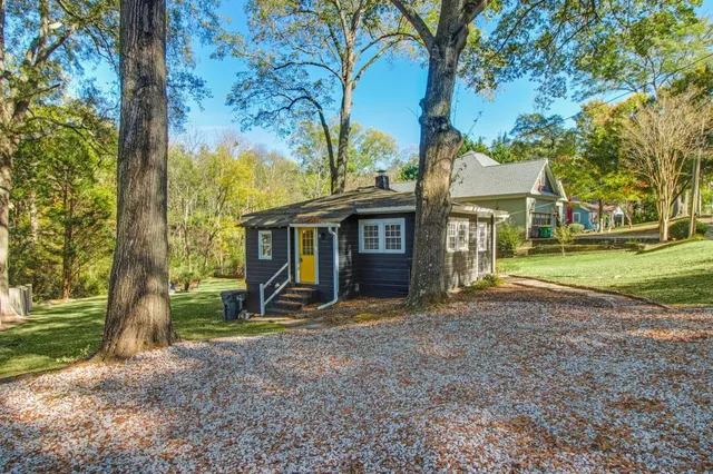 a view of a house with a yard and tree s