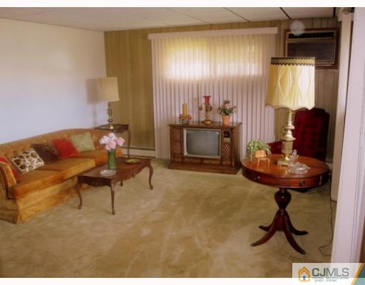 9 Matson Road Edison, NJ 08817 - Photo 2 of 10 a living room with furniture and a fireplace