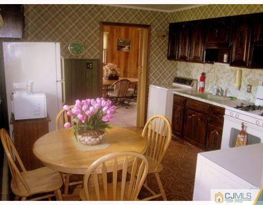 9 Matson Road Edison, NJ 08817 - Photo 3 of 10 a kitchen with stainless steel appliances kitchen island granite countertop a stove a sink a dining table and chairs