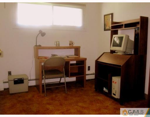 9 Matson Road Edison, NJ 08817 - Photo 8 of 10 a bedroom with a bed and a mirror