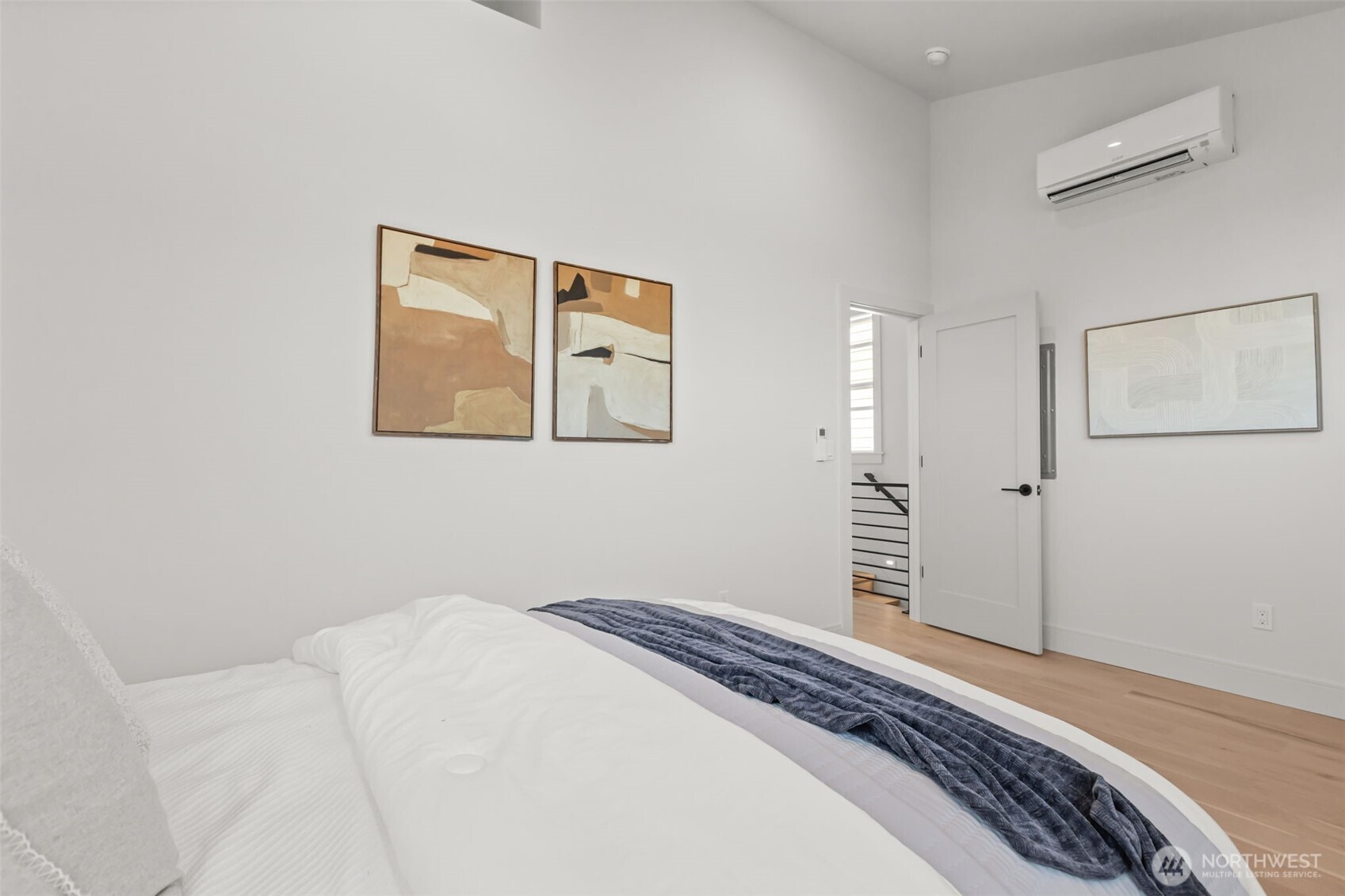 7350 22nd Avenue Northwest, Unit B Seattle, WA 98117 - Photo 14 of 24 a bedroom with a bed and a painting on the wall