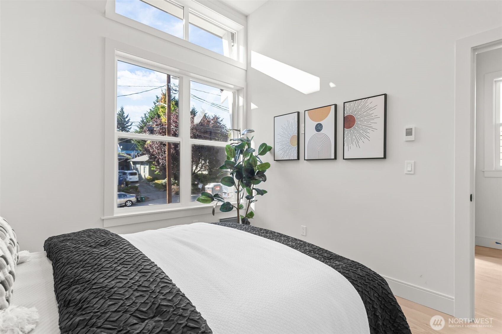 7350 22nd Avenue Northwest, Unit B Seattle, WA 98117 - Photo 18 of 24 a bedroom with a bed and a large window with the outer view