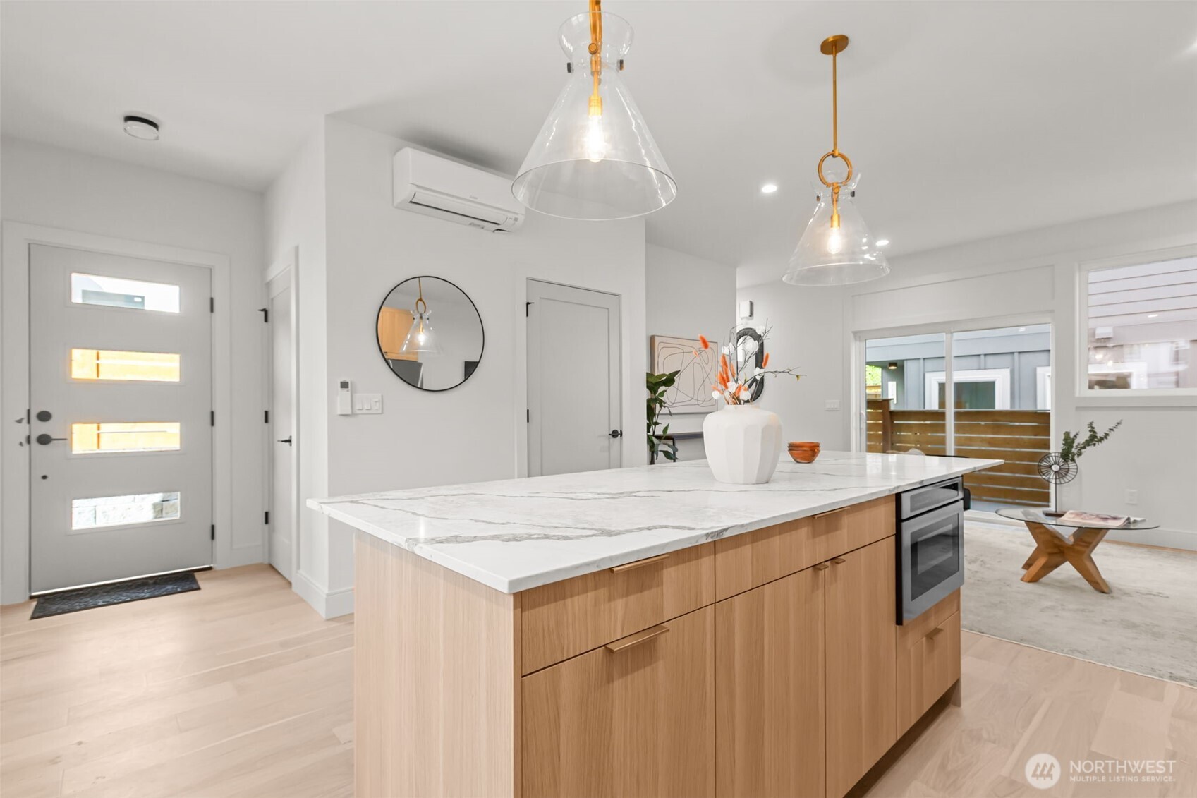 7350 22nd Avenue Northwest, Unit B Seattle, WA 98117 - Photo 9 of 24 a large kitchen with kitchen island a stove a center island a dining table and chairs