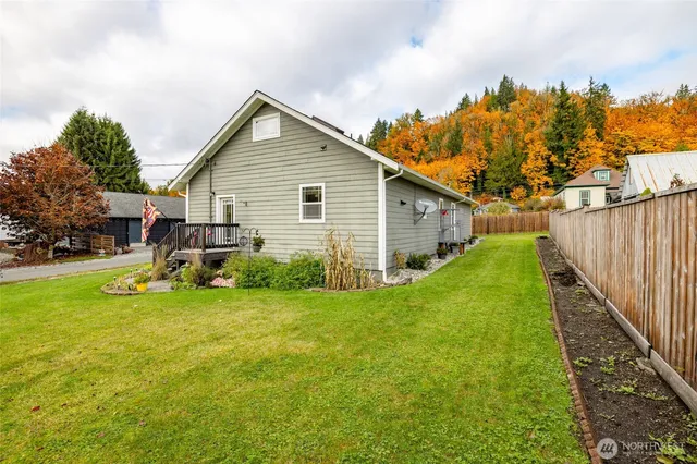 a view of a house with a yard and sitting area