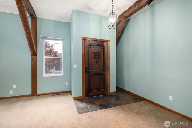 a view of an entryway with wooden floor