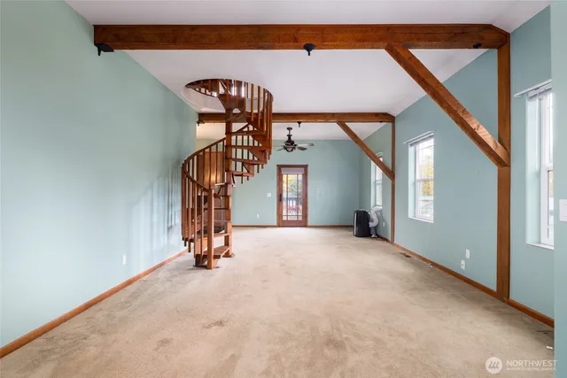 a view of empty room with stairs