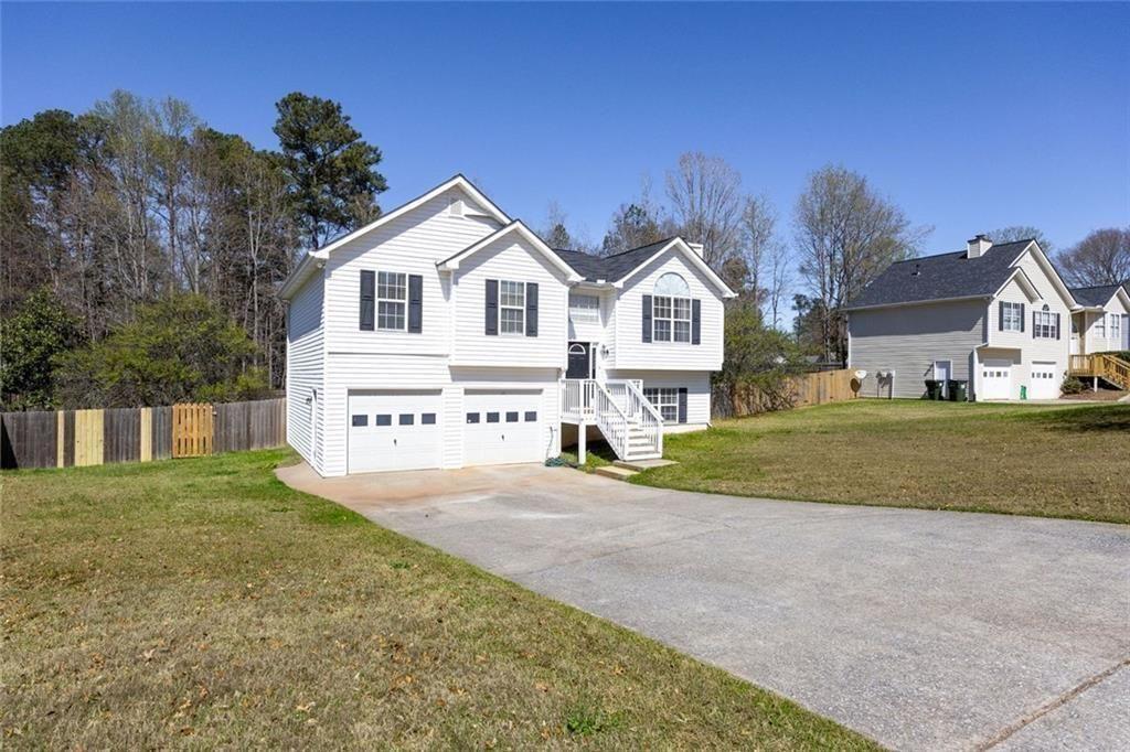a view of house with yard and green space