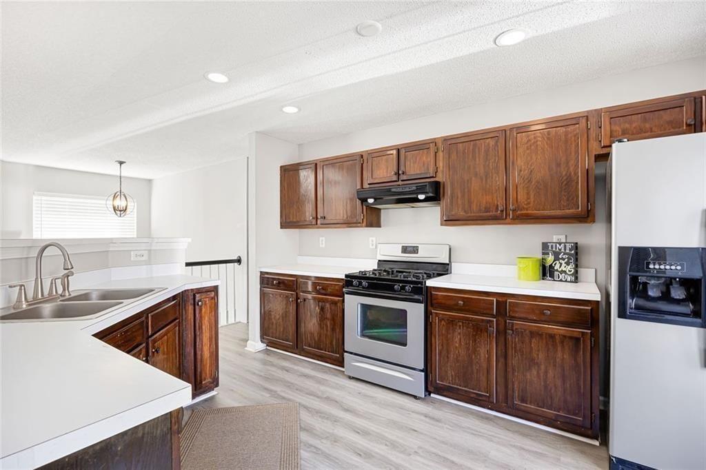 140 Mt Tabor Court Dallas, GA 30157 - Photo 11 of 32 a kitchen with stainless steel appliances granite countertop a sink stove and refrigerator